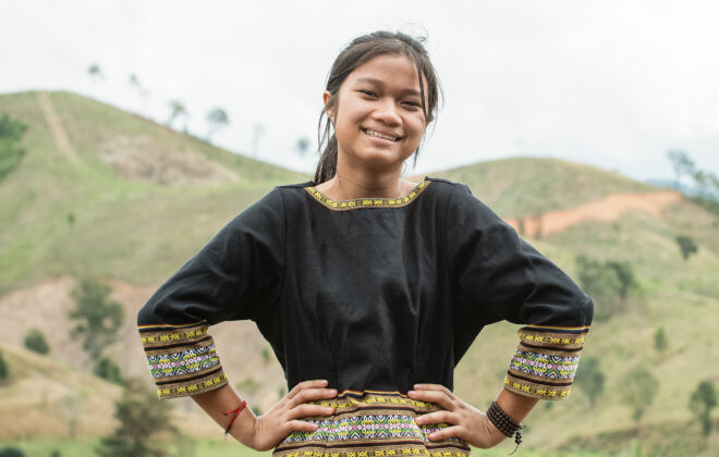 Plan International Suomi työskentelee oikeudenmukaisemman maailman puolesta yhdessä lasten ja nuorten kanssa yli 80 maassa, kuvassa vietnamilainen tyttö seisoo hymyillen päättäväisesti.